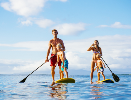 Paddle boarding family with small kids