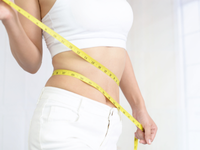 Woman with a tape measure around her waist